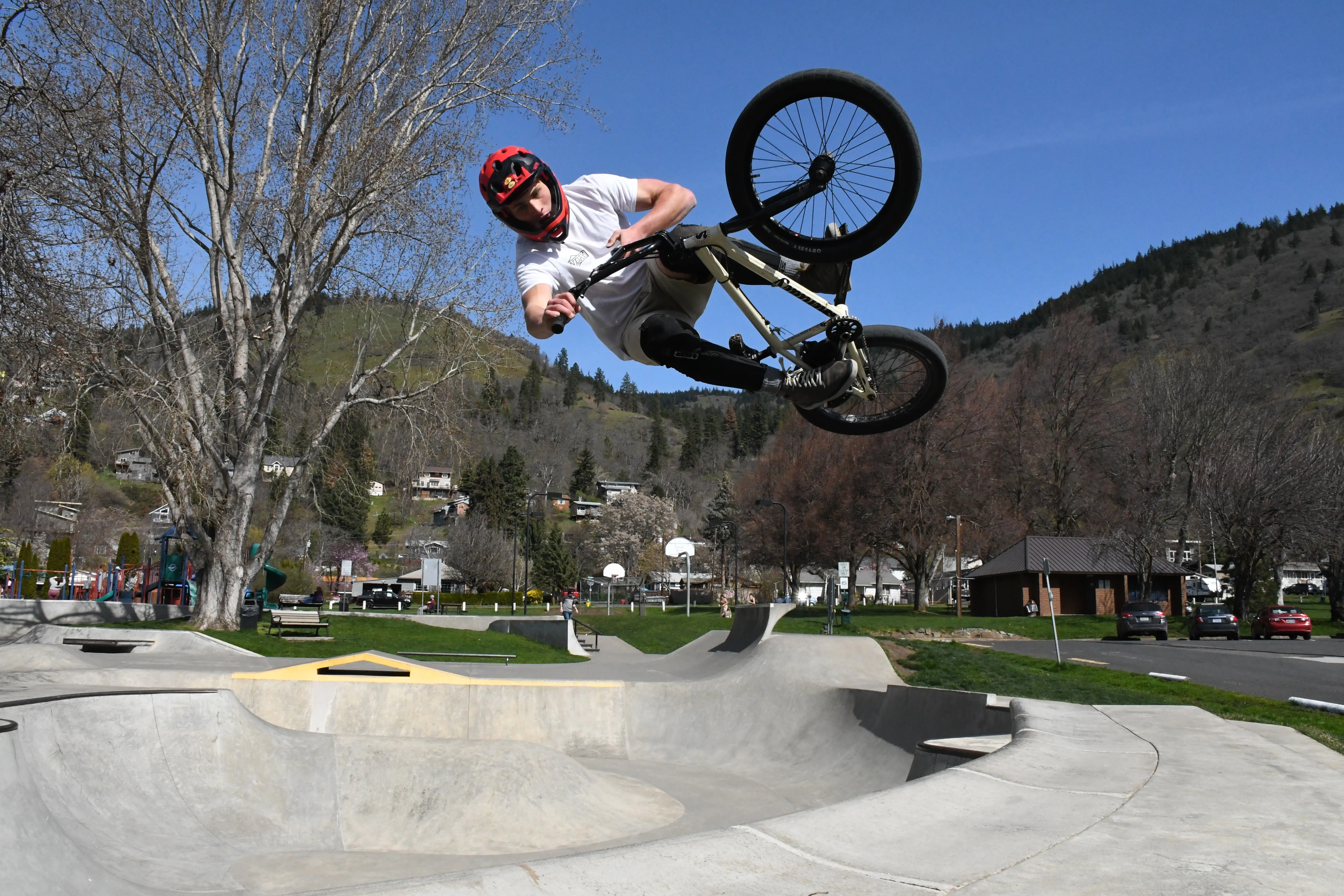 Chris Hulbert performs a trick on his bike at Daubenspeck Park in Bingen, Wash., July 2021